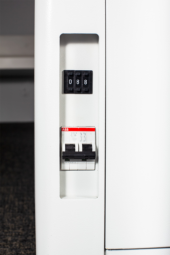 Close-up of adjustable over-temperature switch and circuit breaker/power switch